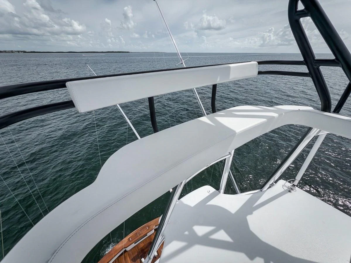A close-up view of the yacht's upper deck railing and seating area overlooking the sea. aboard GENESIS Yacht for Sale