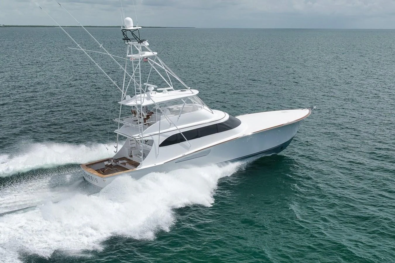 A sleek yacht cruises swiftly through the open water, showcasing its elegant design and powerful performance. aboard GENESIS Yacht for Sale