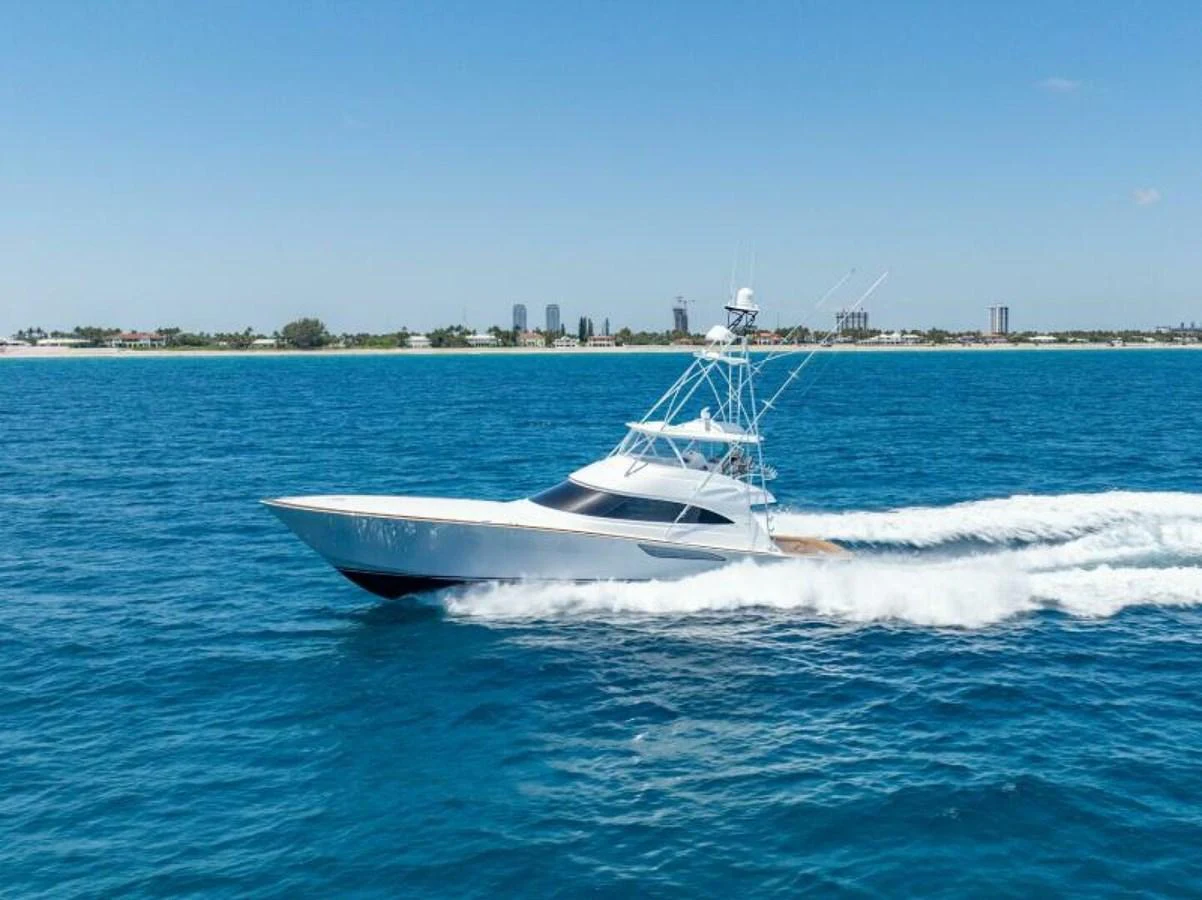 A sleek yacht cruises swiftly across the open water on a clear day. aboard 2027 VIKING 74C Yacht for Sale