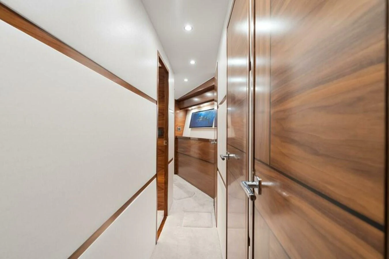 A sleek and modern hallway with wood paneling and recessed lighting. aboard 2027 VIKING 74C Yacht for Sale