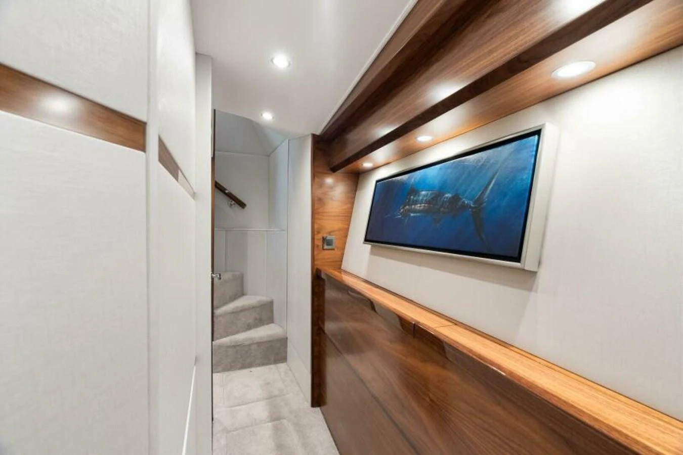 A sleek and modern hallway with elegant wooden accents and a large framed artwork. aboard 2027 VIKING 74C Yacht for Sale