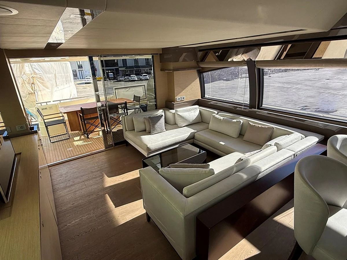 The salon features a spacious and elegant seating area with large windows offering ample natural light. aboard LA LUNA Yacht for Sale