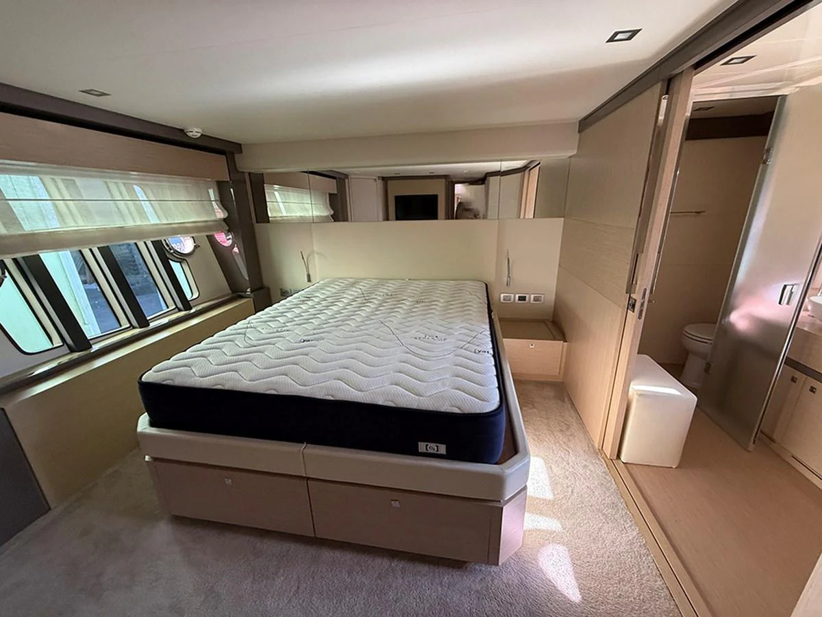 A luxurious stateroom featuring a comfortable bed and modern decor. aboard LA LUNA Yacht for Sale