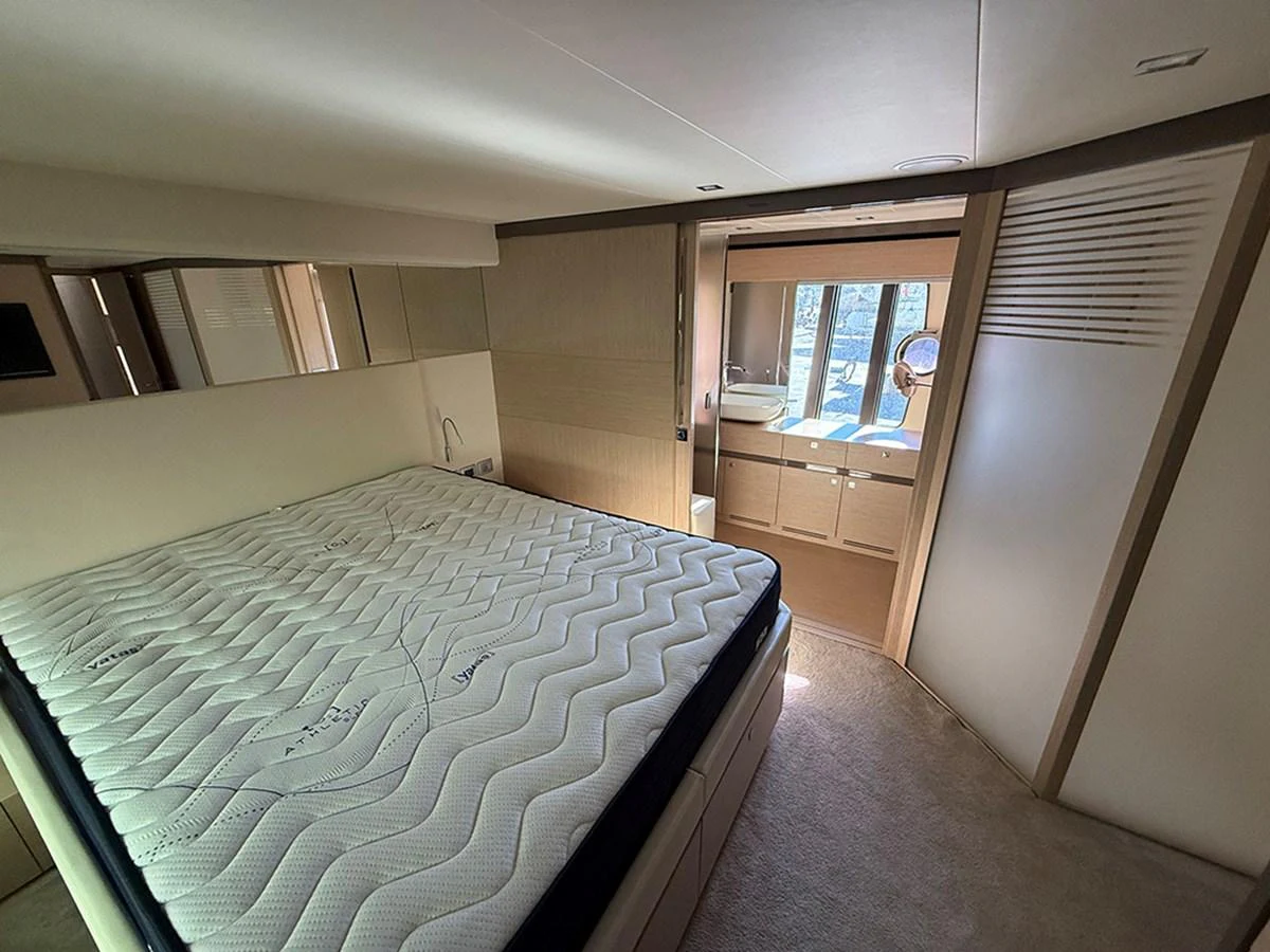 A well-appointed stateroom featuring a large bed and ample natural light from the windows. aboard LA LUNA Yacht for Sale