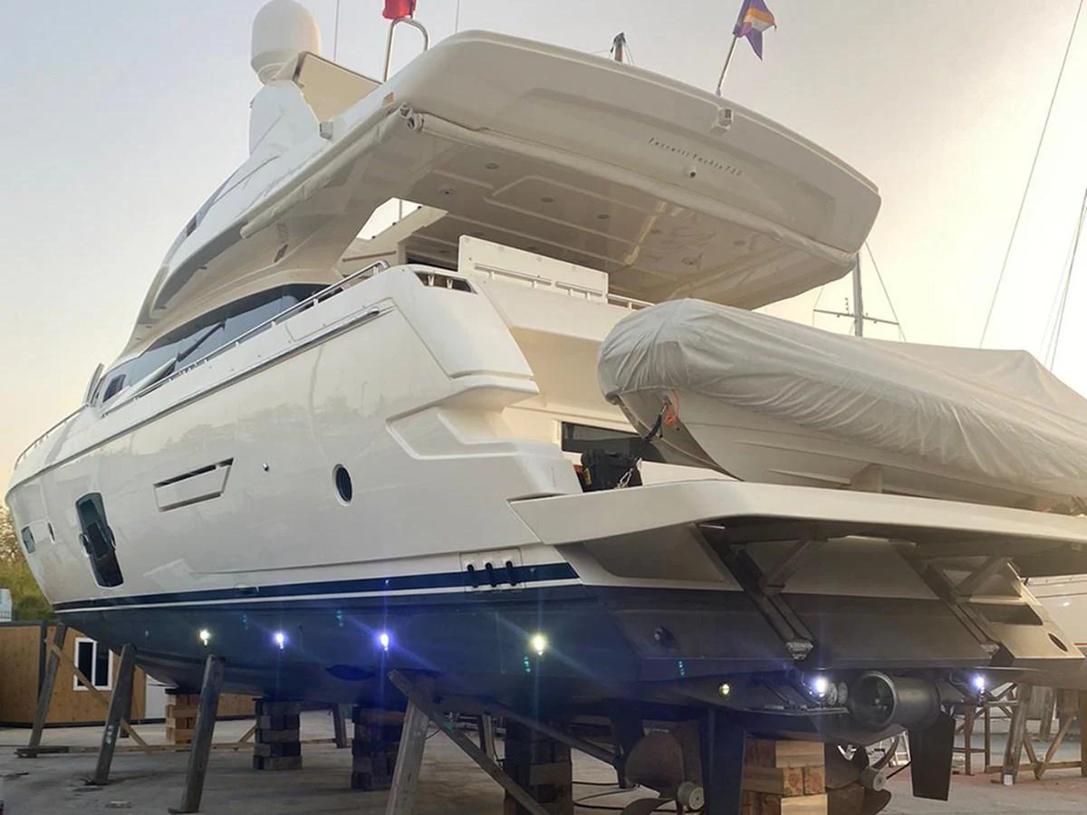 The yacht is showcased on dry dock, highlighting its sleek design and underbody structure. aboard LA LUNA Yacht for Sale