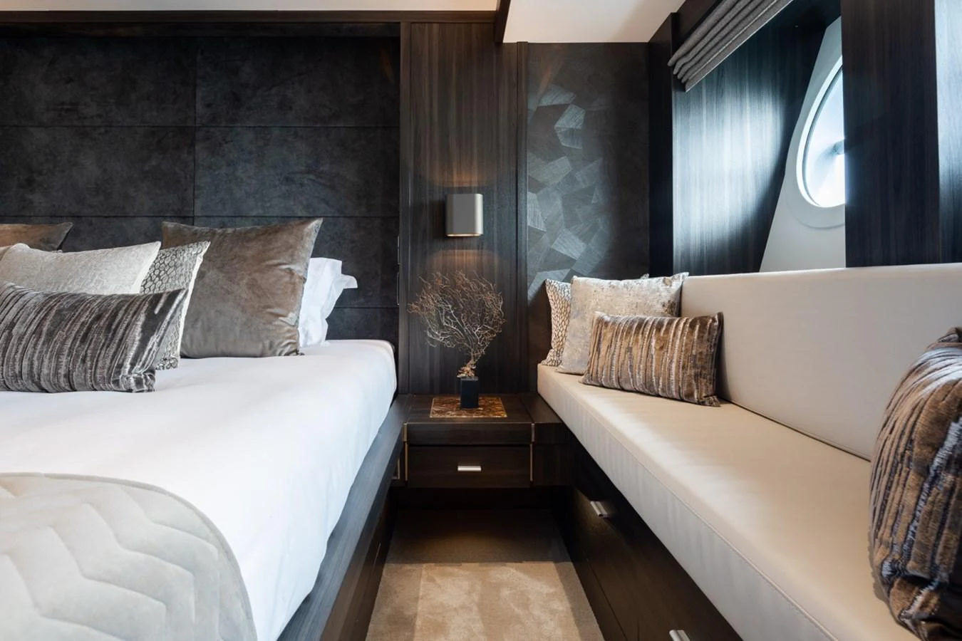 A luxurious stateroom featuring elegant bedding and modern decor. aboard TAIMARE Yacht for Sale
