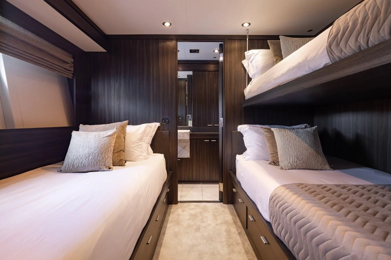 The guest stateroom features twin beds and elegant wood paneling. aboard TAIMARE Yacht for Sale