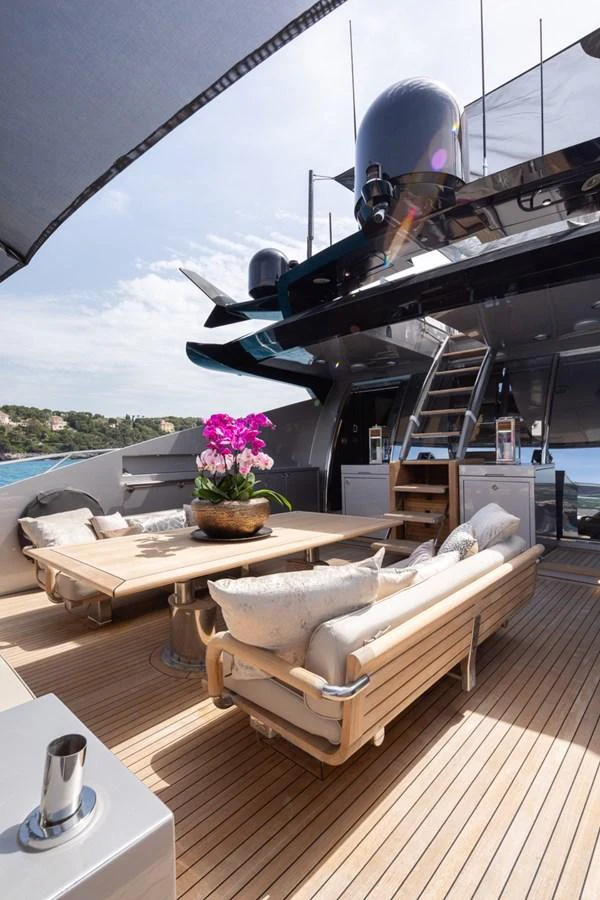 The aft deck features comfortable seating and a stylish table arrangement, perfect for relaxation and socializing. aboard TAIMARE Yacht for Sale