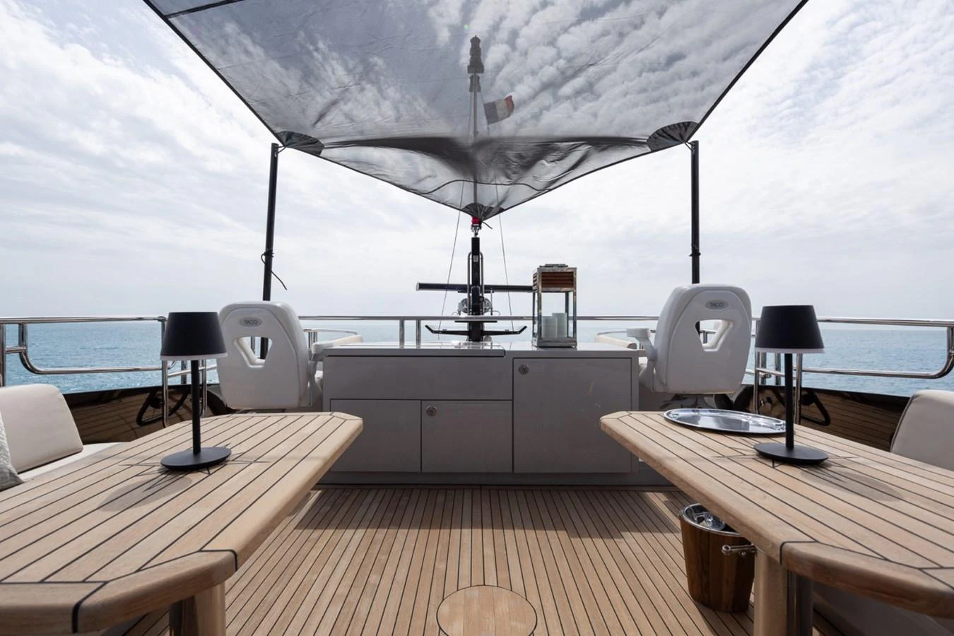 The flybridge offers a spacious and shaded area for relaxation and dining. aboard TAIMARE Yacht for Sale
