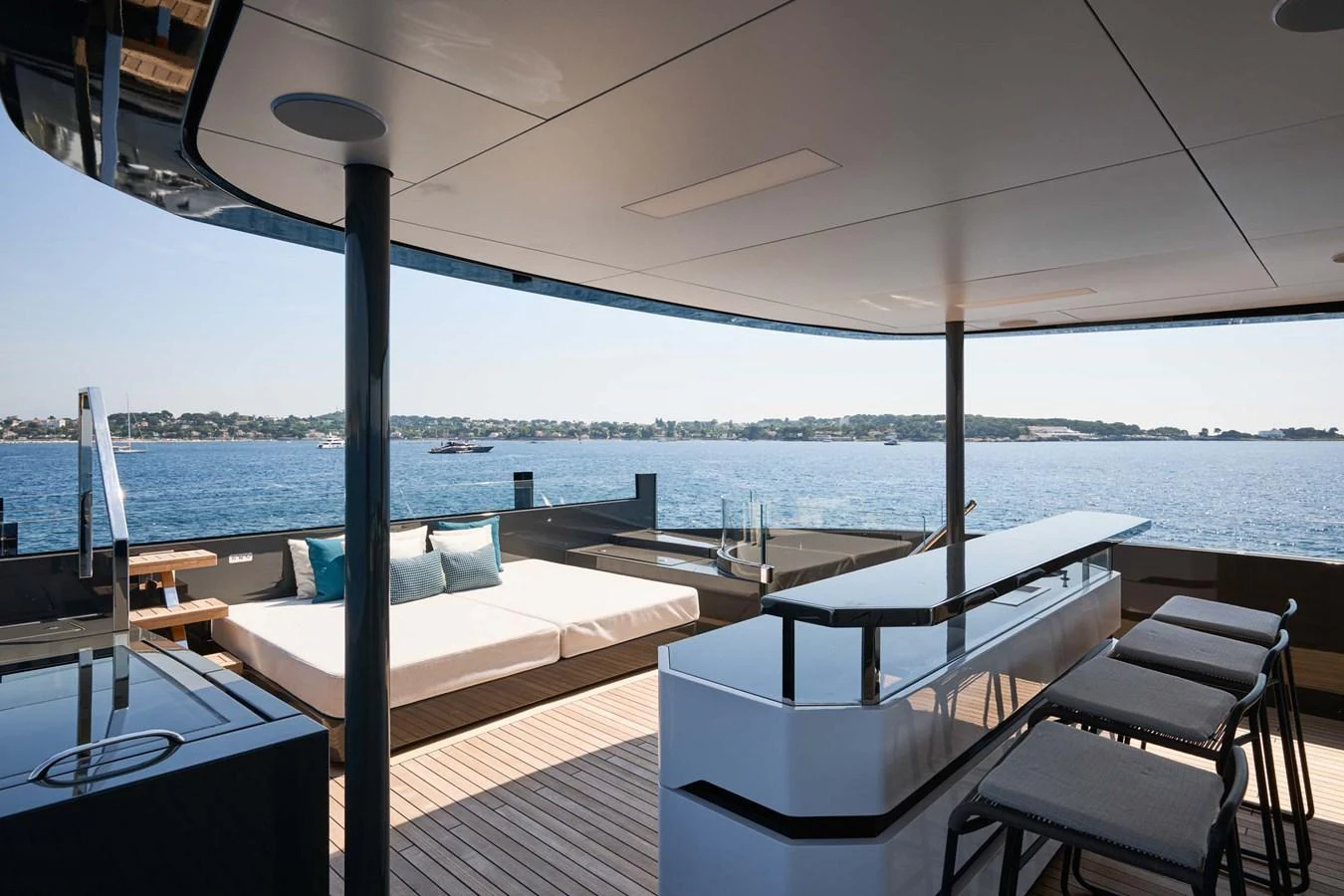 The sundeck offers a luxurious space with a bar and lounging area overlooking the water. aboard LOEWE Yacht for Sale