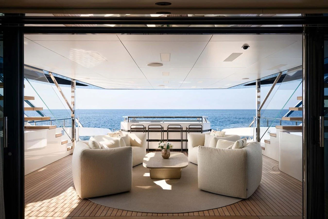 The aft deck offers a luxurious seating area with stunning ocean views. aboard LOEWE Yacht for Sale