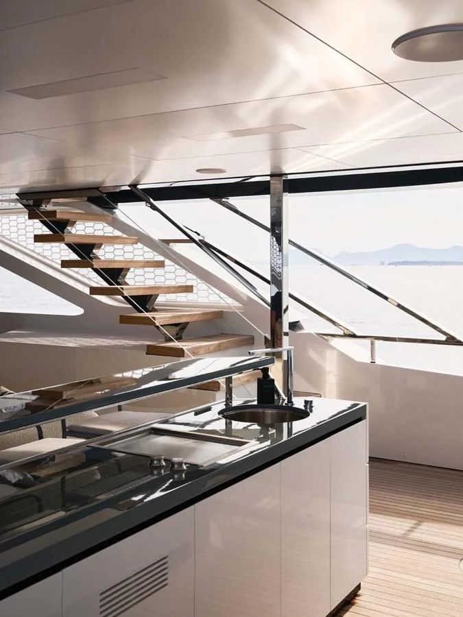 A sleek and modern interior staircase with a view of the sea. aboard LOEWE Yacht for Sale