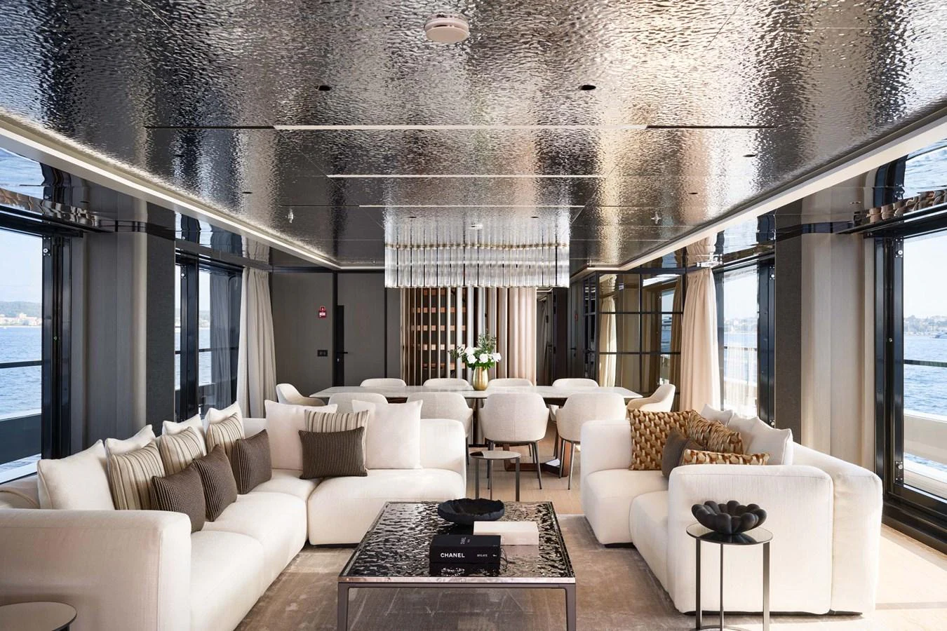 The salon features luxurious seating with panoramic views through large windows. aboard LOEWE Yacht for Sale