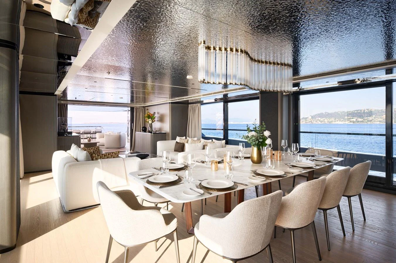 The yacht's dining area features elegant seating and a stunning view of the sea. aboard LOEWE Yacht for Sale