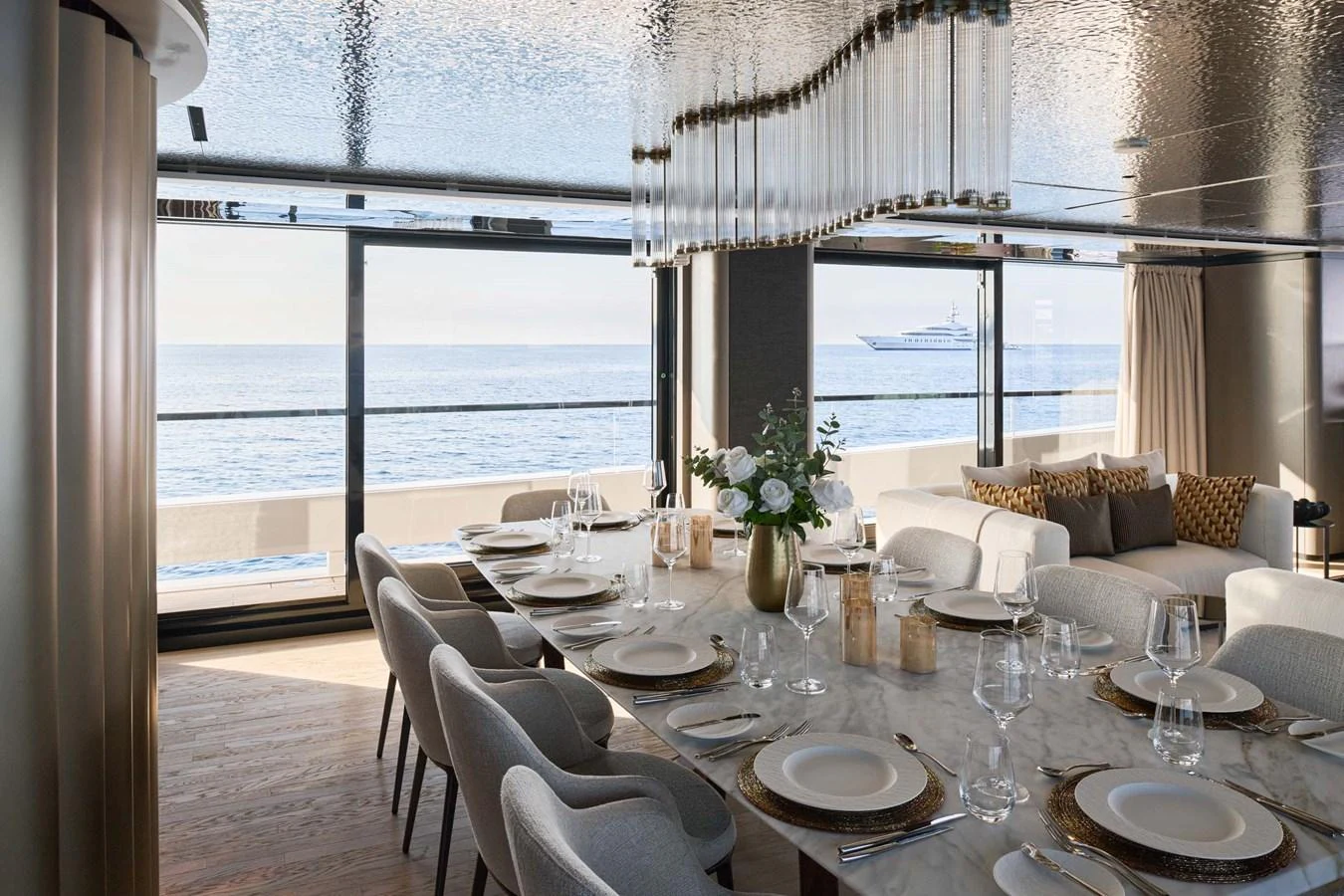The elegant dining area offers stunning sea views through large windows. aboard LOEWE Yacht for Sale