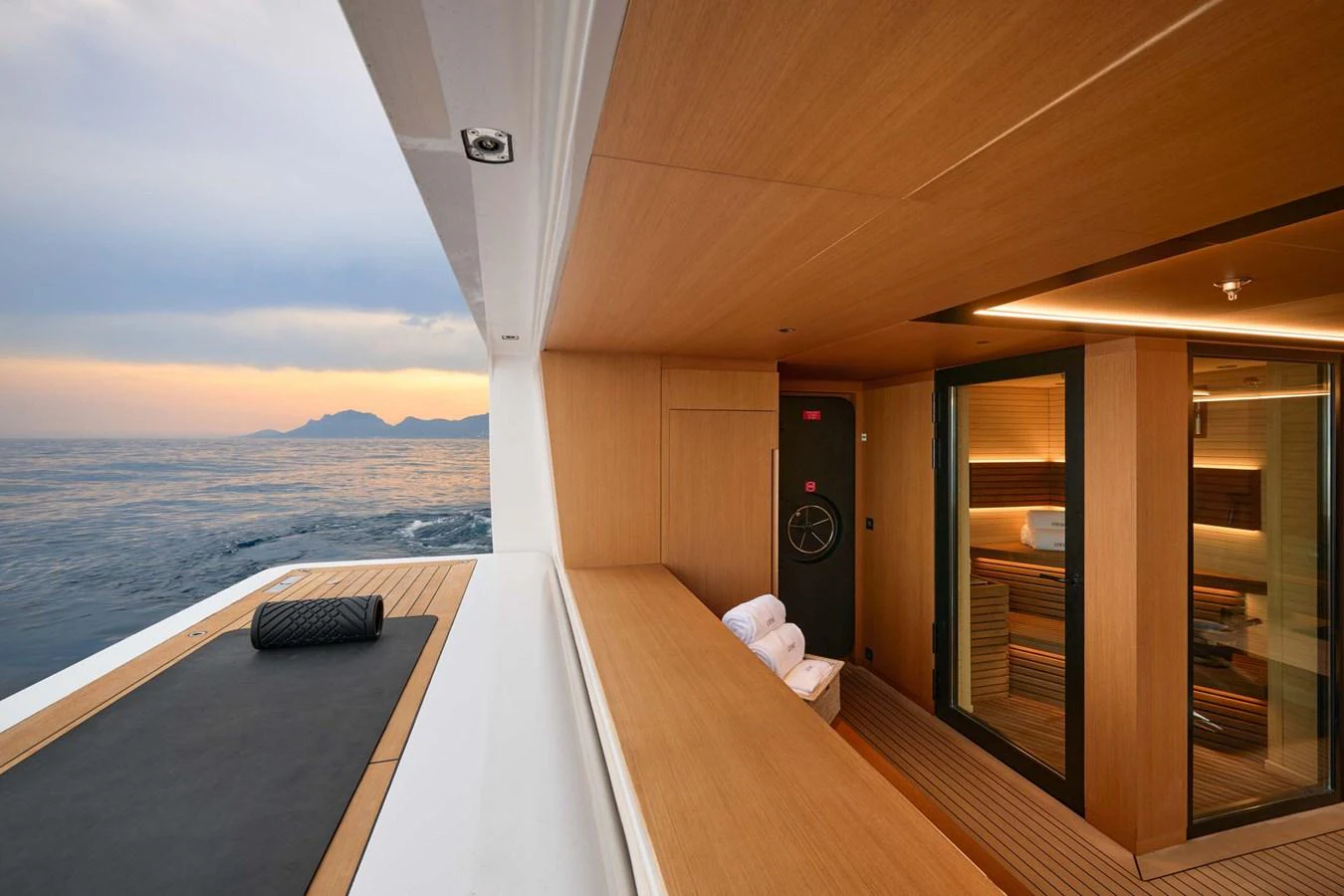 This image showcases a luxurious onboard sauna with a serene ocean backdrop. aboard LOEWE Yacht for Sale