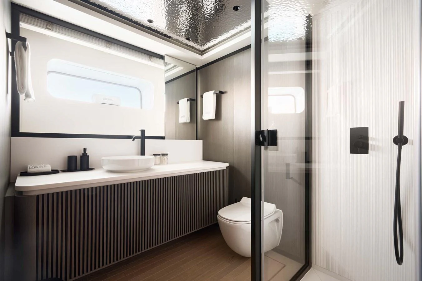 The yacht's bathroom features a sleek, modern design with high-end fixtures and ample natural light. aboard LOEWE Yacht for Sale
