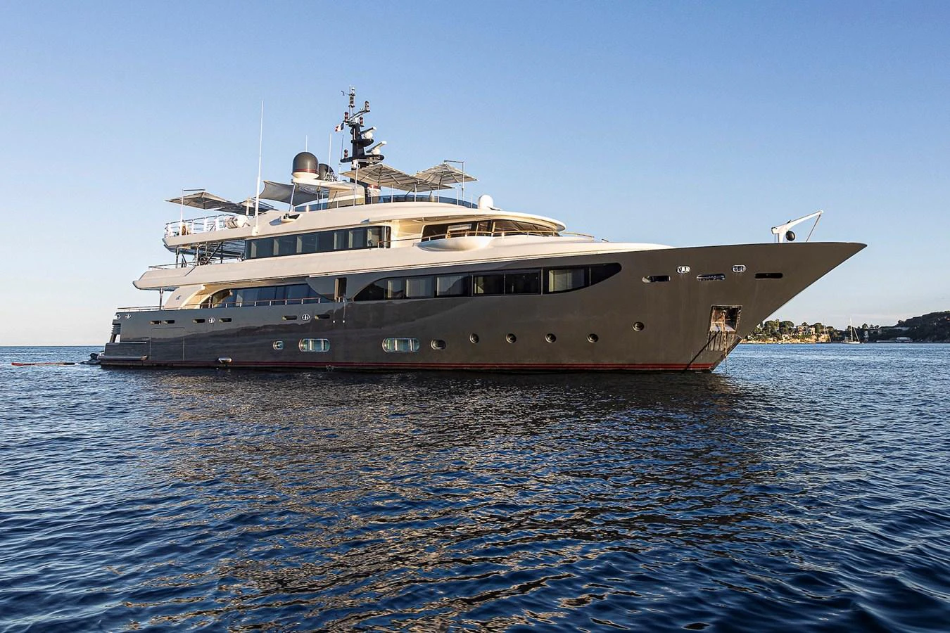 A sleek and modern yacht is anchored on calm waters, showcasing its elegant design and spacious decks. aboard LADY TRUDY Yacht for Sale