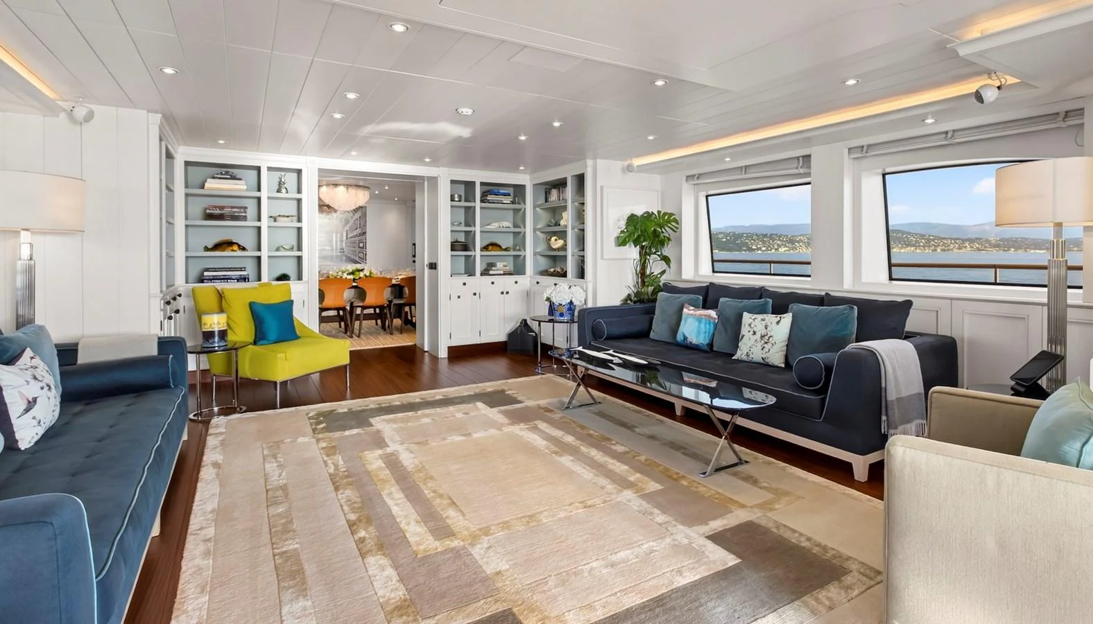 The spacious salon features elegant furnishings and large windows offering stunning views. aboard LADY TRUDY Yacht for Sale