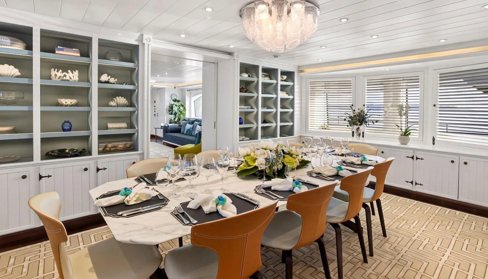 The yacht's dining area features an elegant table setting with a modern, inviting ambiance. aboard LADY TRUDY Yacht for Sale