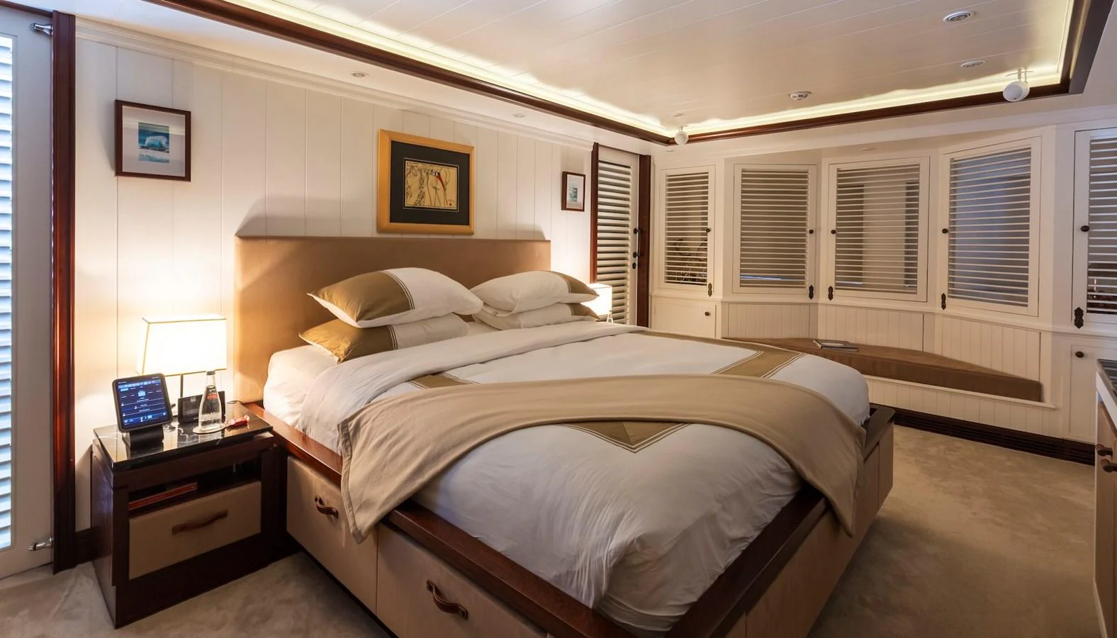 The master stateroom features a luxurious bed with elegant bedding and warm lighting. aboard LADY TRUDY Yacht for Sale