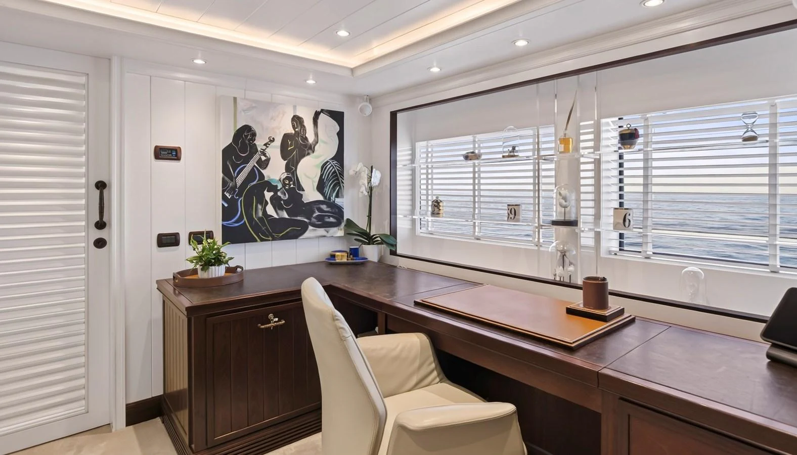 The yacht's office features a sophisticated workspace with a large desk, comfortable chair, and ample natural light from the windows. aboard LADY TRUDY Yacht for Sale