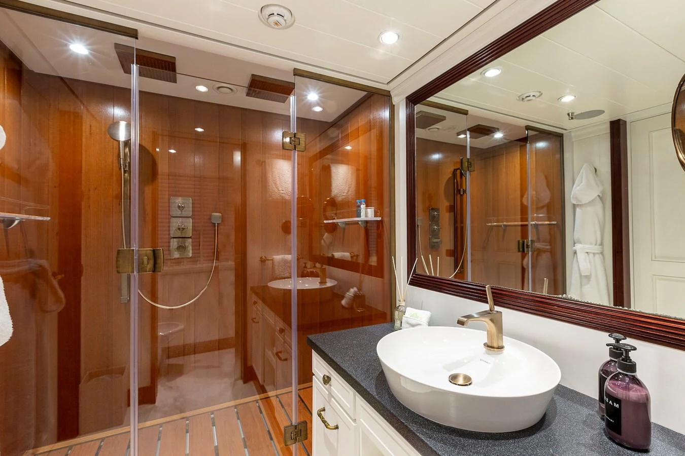The yacht's bathroom features a luxurious glass-enclosed shower and elegant fixtures. aboard LADY TRUDY Yacht for Sale