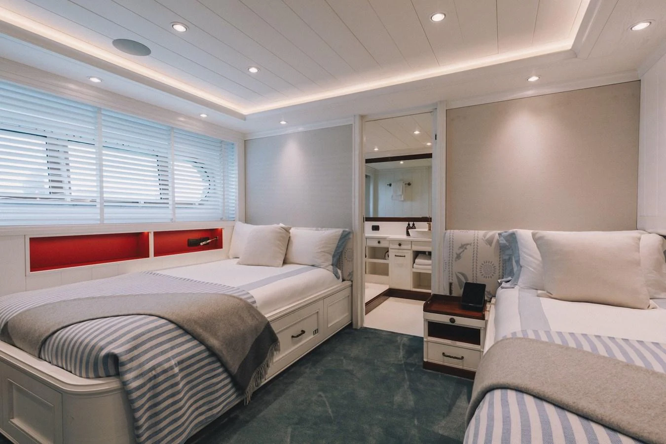 The guest stateroom features twin beds with cozy bedding and a modern, serene design. aboard LADY TRUDY Yacht for Sale