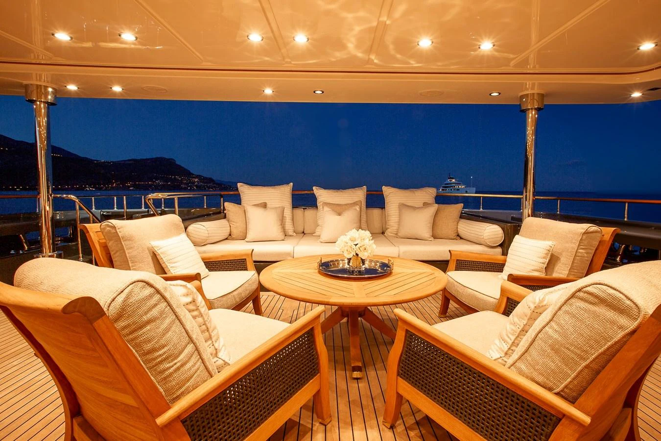 The aft deck features a cozy seating area with plush cushions and ambient lighting, perfect for evening relaxation. aboard LADY TRUDY Yacht for Sale