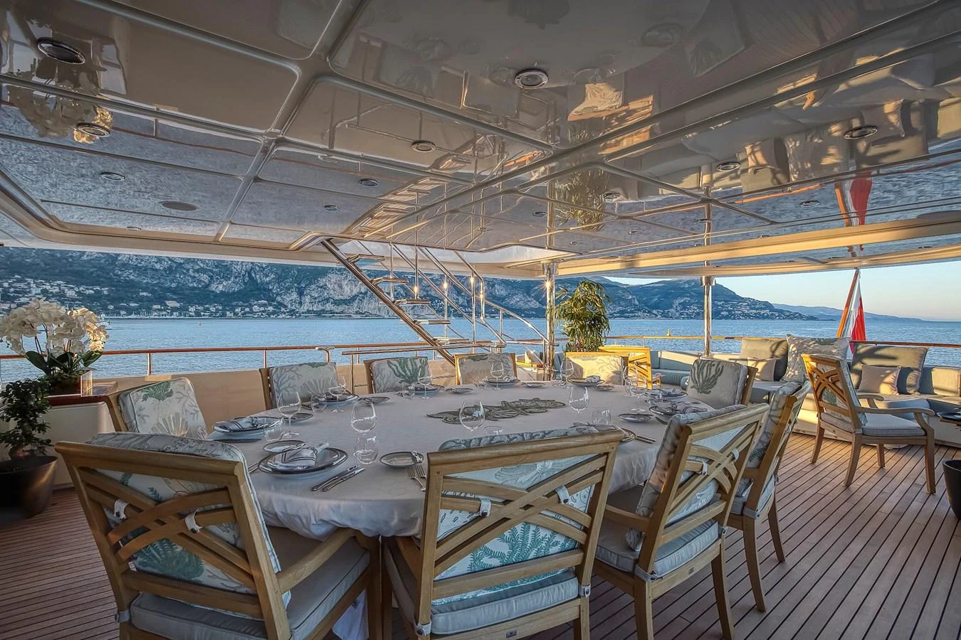 The aft deck features an elegant dining area with a stunning view of the sea and mountains. aboard LADY TRUDY Yacht for Sale