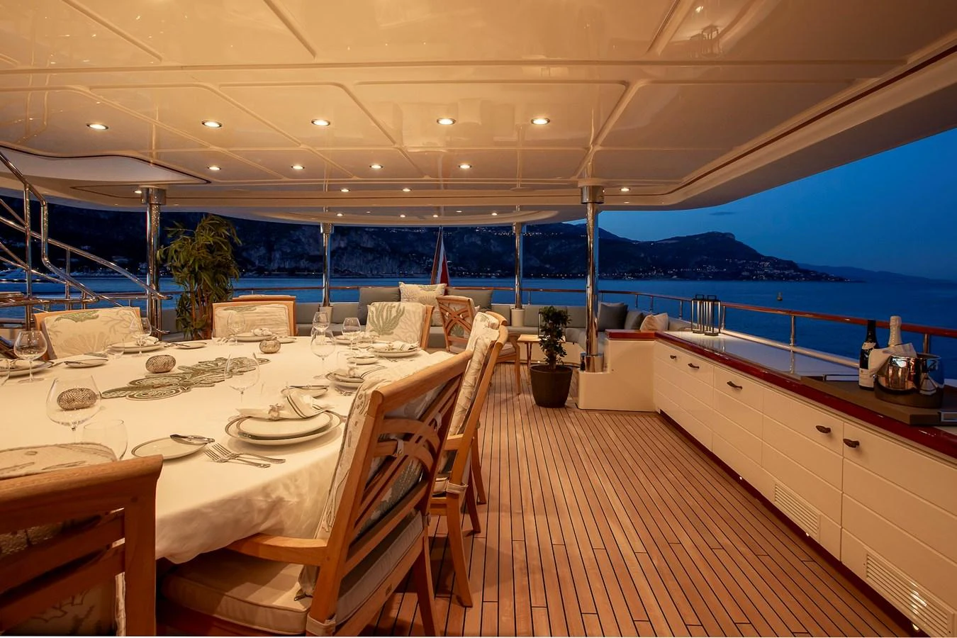 The aft deck features an elegant dining area with a stunning ocean view. aboard LADY TRUDY Yacht for Sale