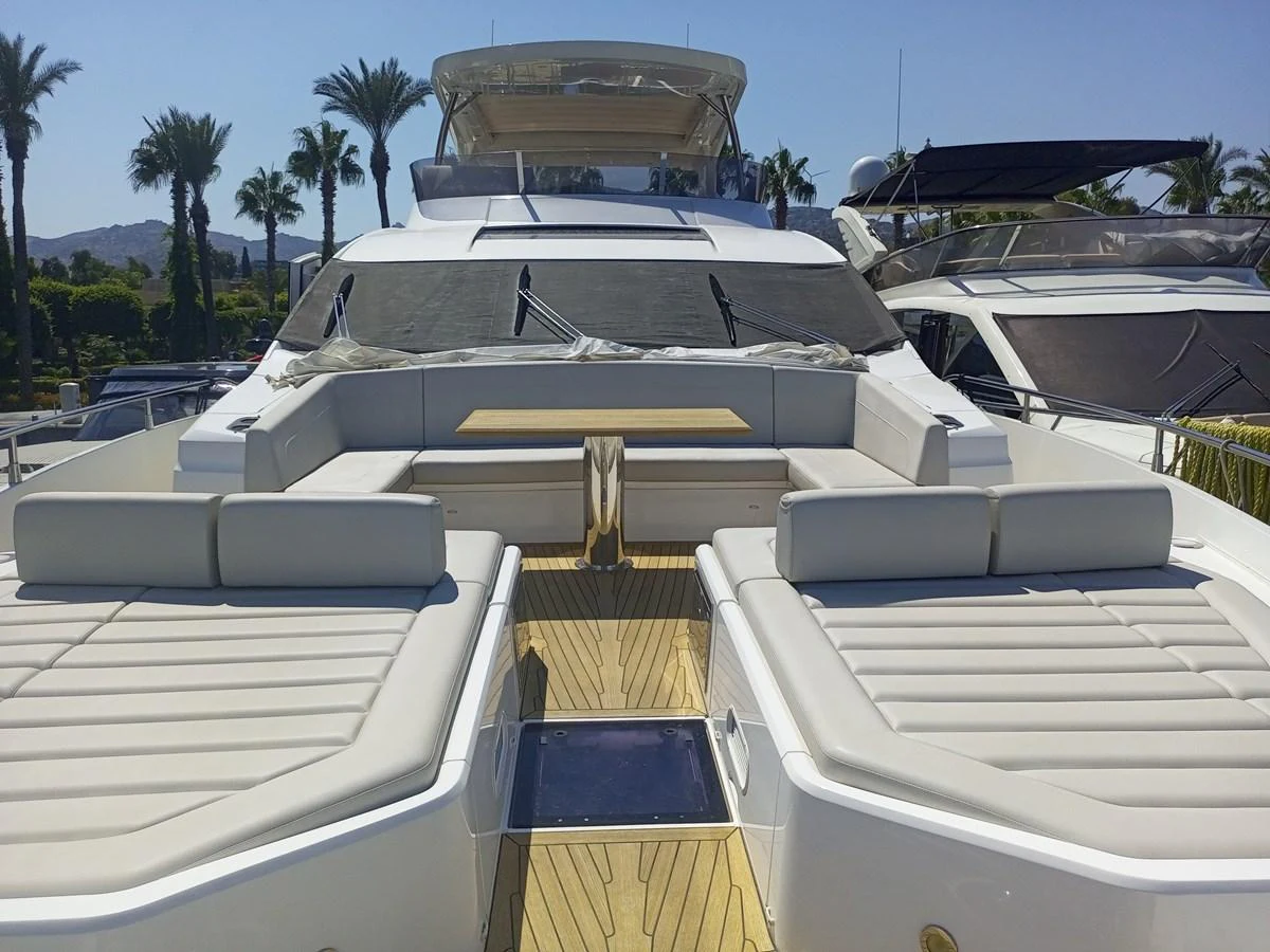 The foredeck of this yacht features luxurious sun pads and a spacious seating area with a table, perfect for relaxation and socializing. aboard ANM Yacht for Sale