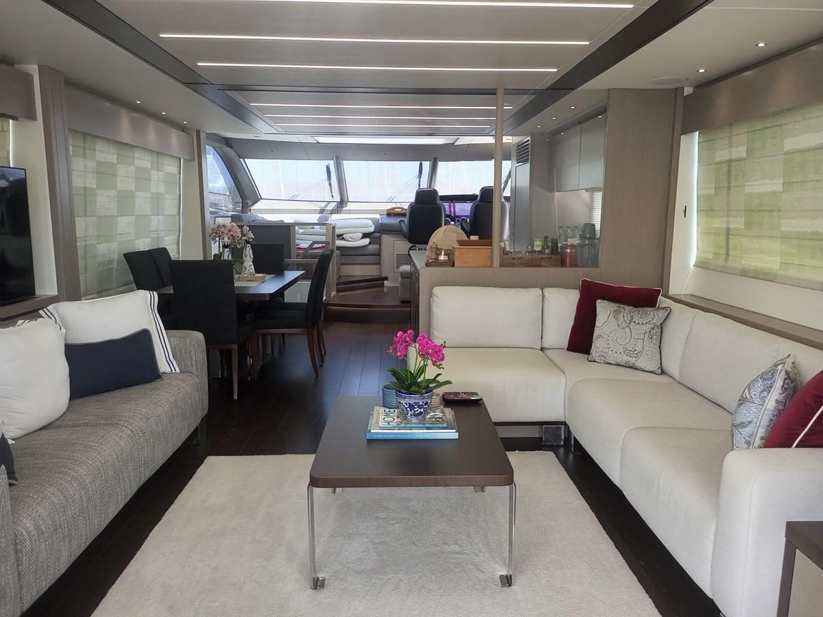The salon features elegant seating with a modern design and ample natural light. aboard ANM Yacht for Sale