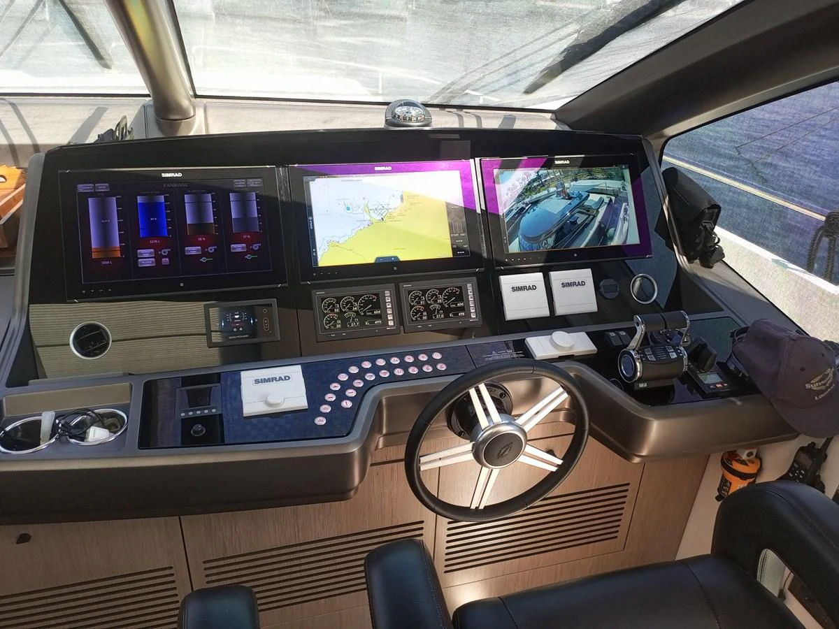 The helm station features advanced navigation equipment and a sleek, modern design. aboard ANM Yacht for Sale