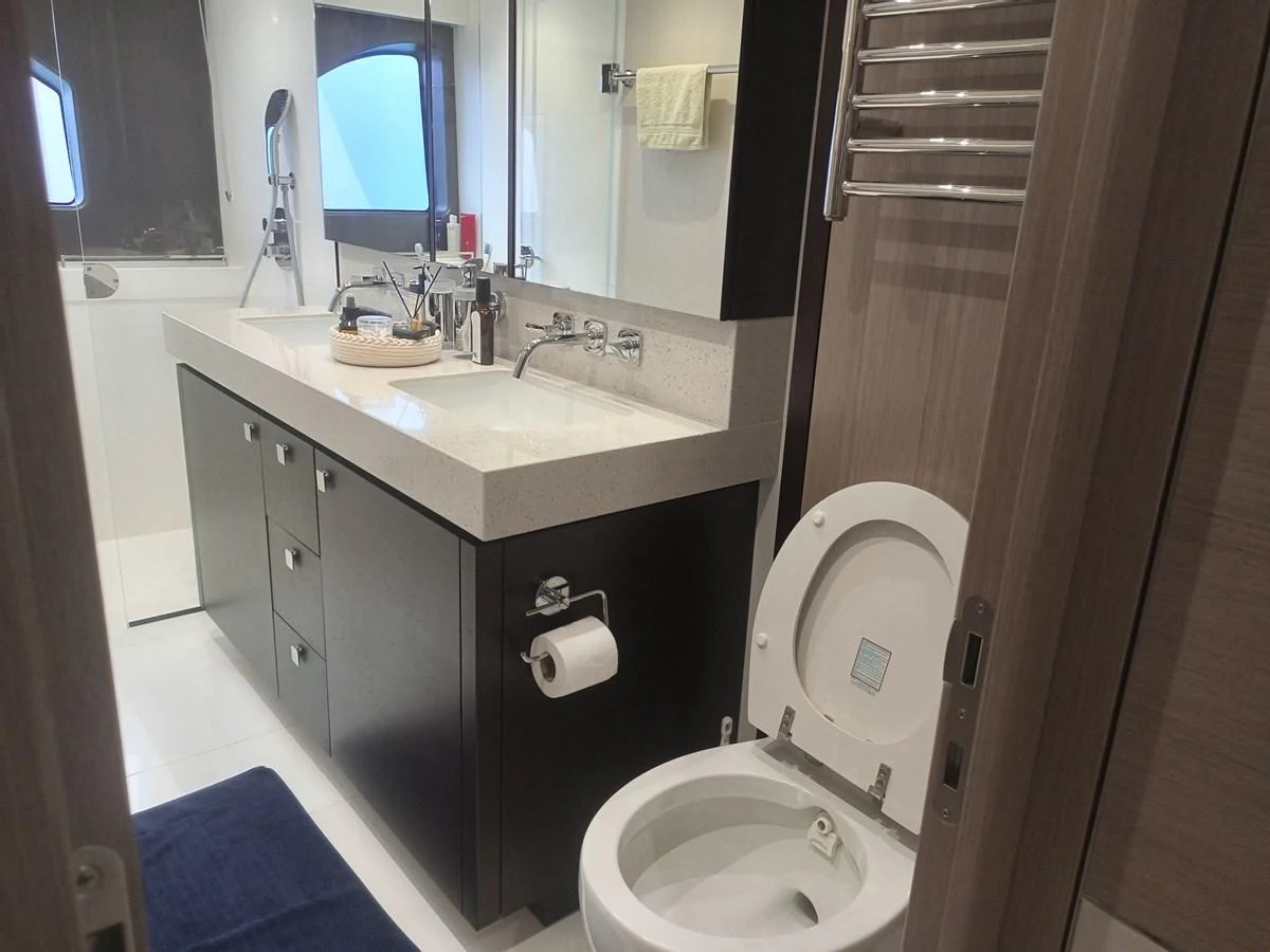 The yacht's bathroom features a sleek design with modern fixtures and ample counter space. aboard ANM Yacht for Sale