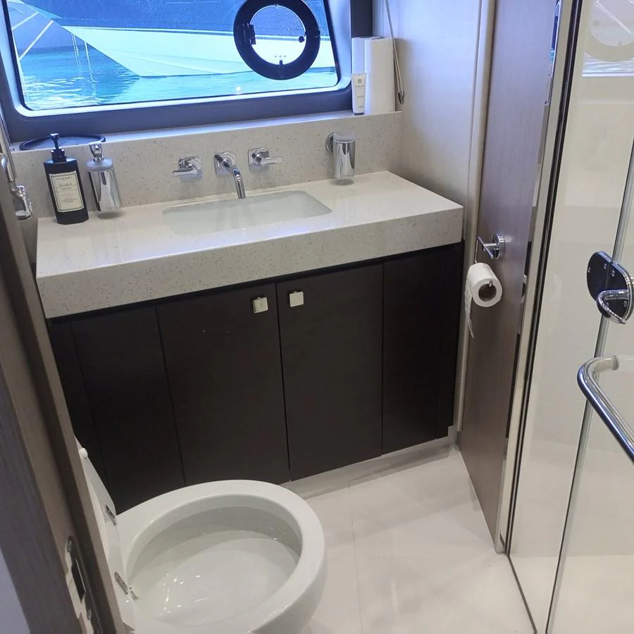 The yacht's bathroom features a modern sink, toilet, and ample storage space. aboard ANM Yacht for Sale