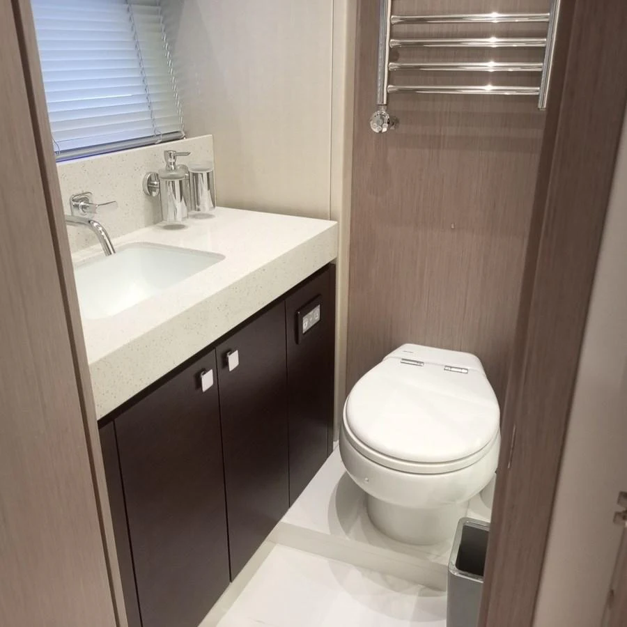 The yacht's head features modern fixtures and a sleek design. aboard ANM Yacht for Sale