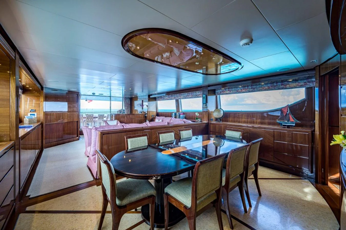 The yacht's dining area features elegant furnishings and expansive windows offering stunning views. aboard ALEGHI Yacht for Sale