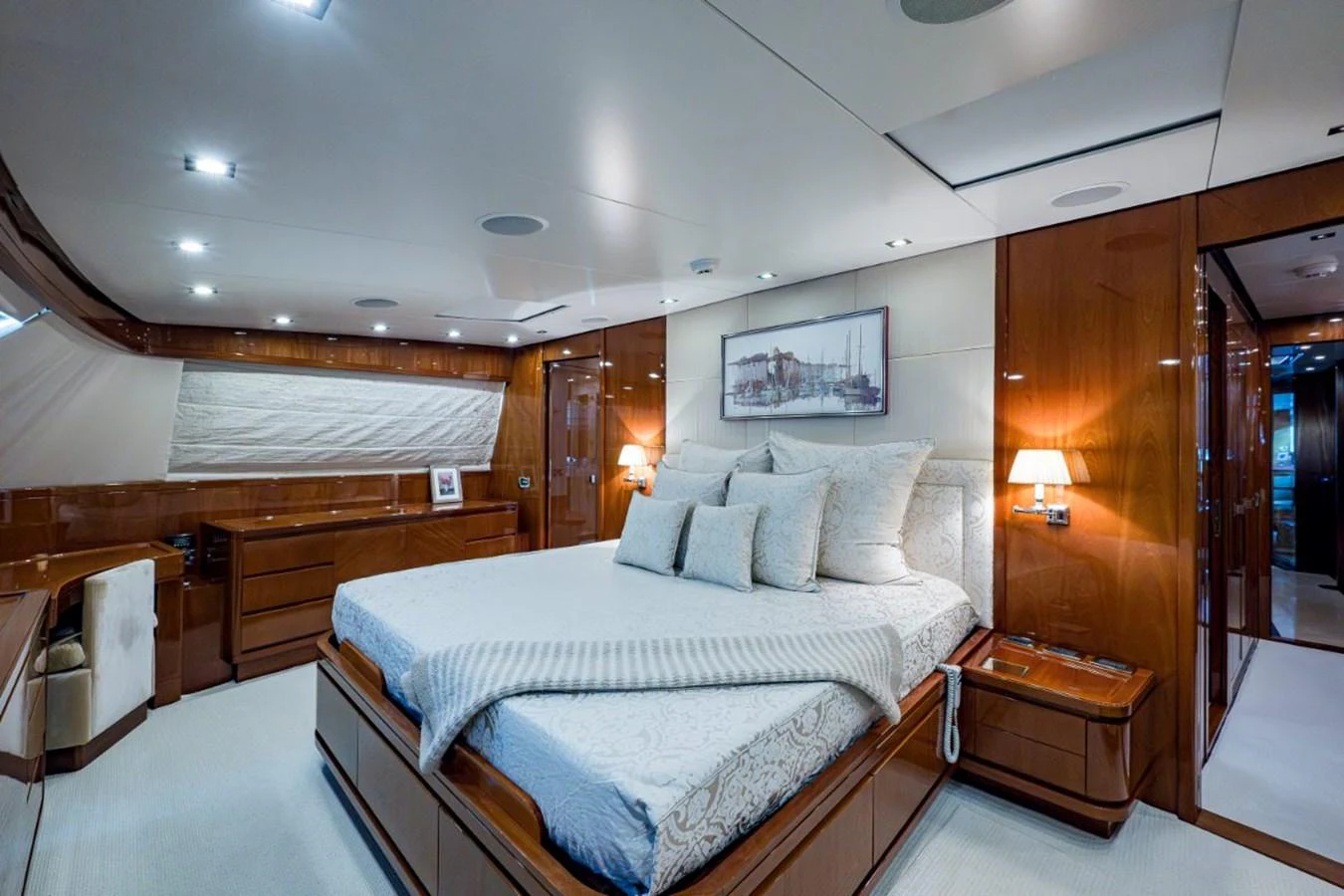 The master stateroom features a luxurious bed with elegant wood paneling and soft lighting. aboard ALEGHI Yacht for Sale