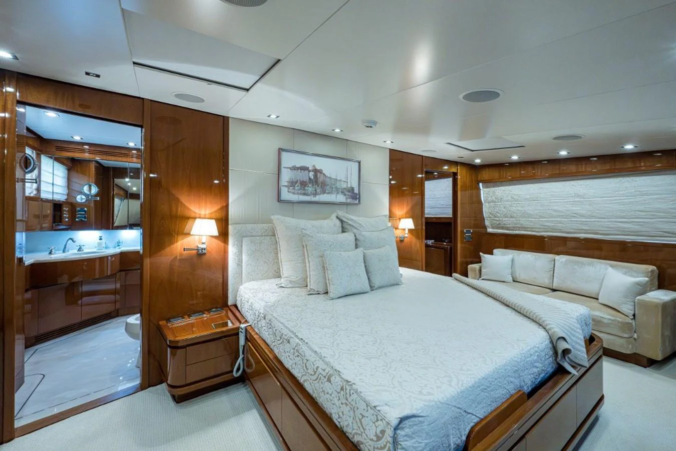 The master stateroom features a spacious bed, elegant wood paneling, and a cozy seating area. aboard ALEGHI Yacht for Sale