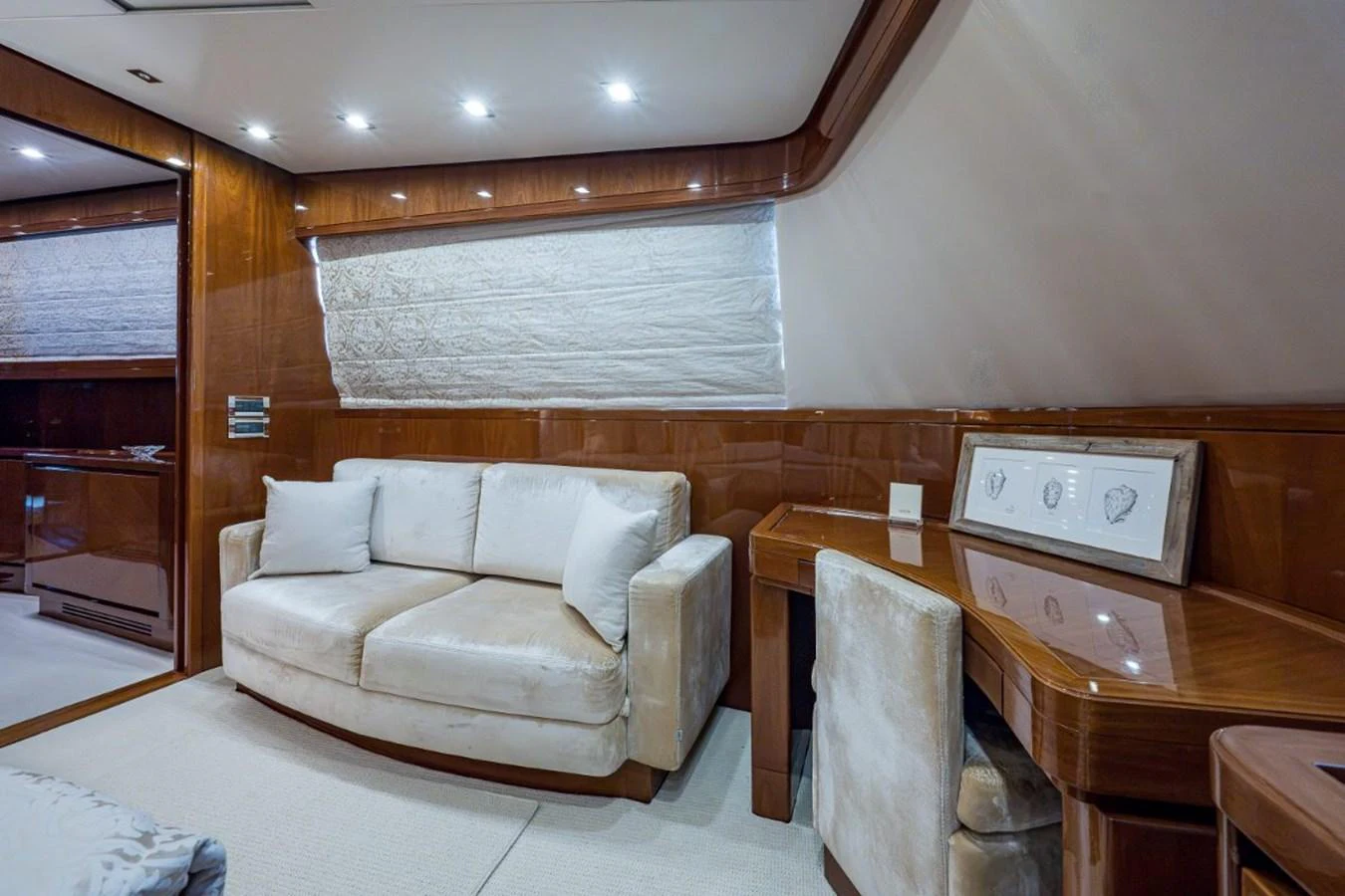 The yacht's interior features a cozy seating area with plush furnishings and elegant wood paneling. aboard ALEGHI Yacht for Sale