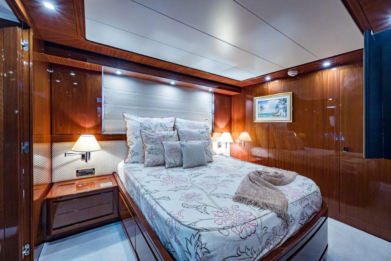 The stateroom features a luxurious bed with elegant bedding and warm lighting. aboard ALEGHI Yacht for Sale