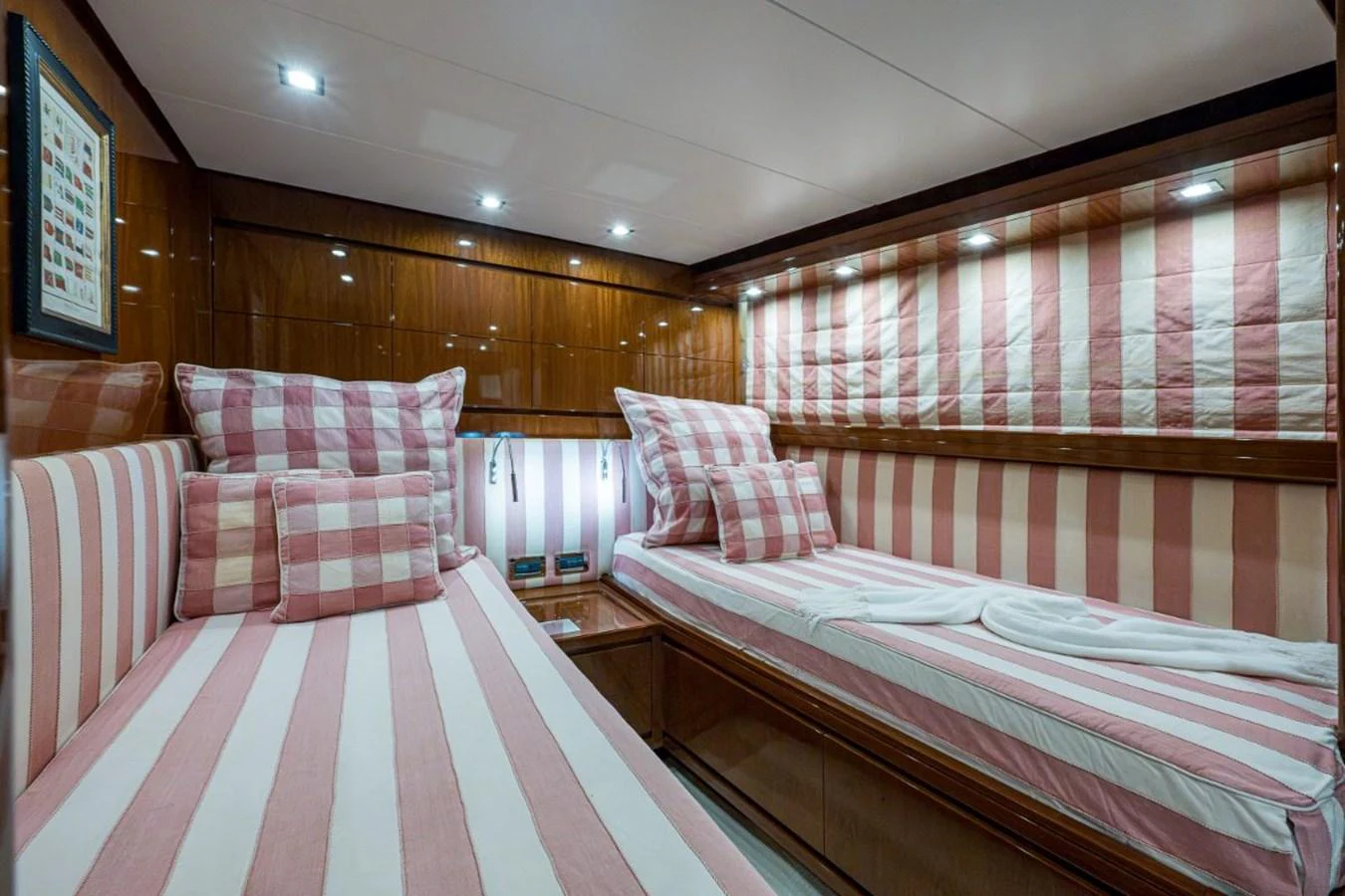 The twin stateroom features cozy beds with striped bedding and warm wooden paneling. aboard ALEGHI Yacht for Sale