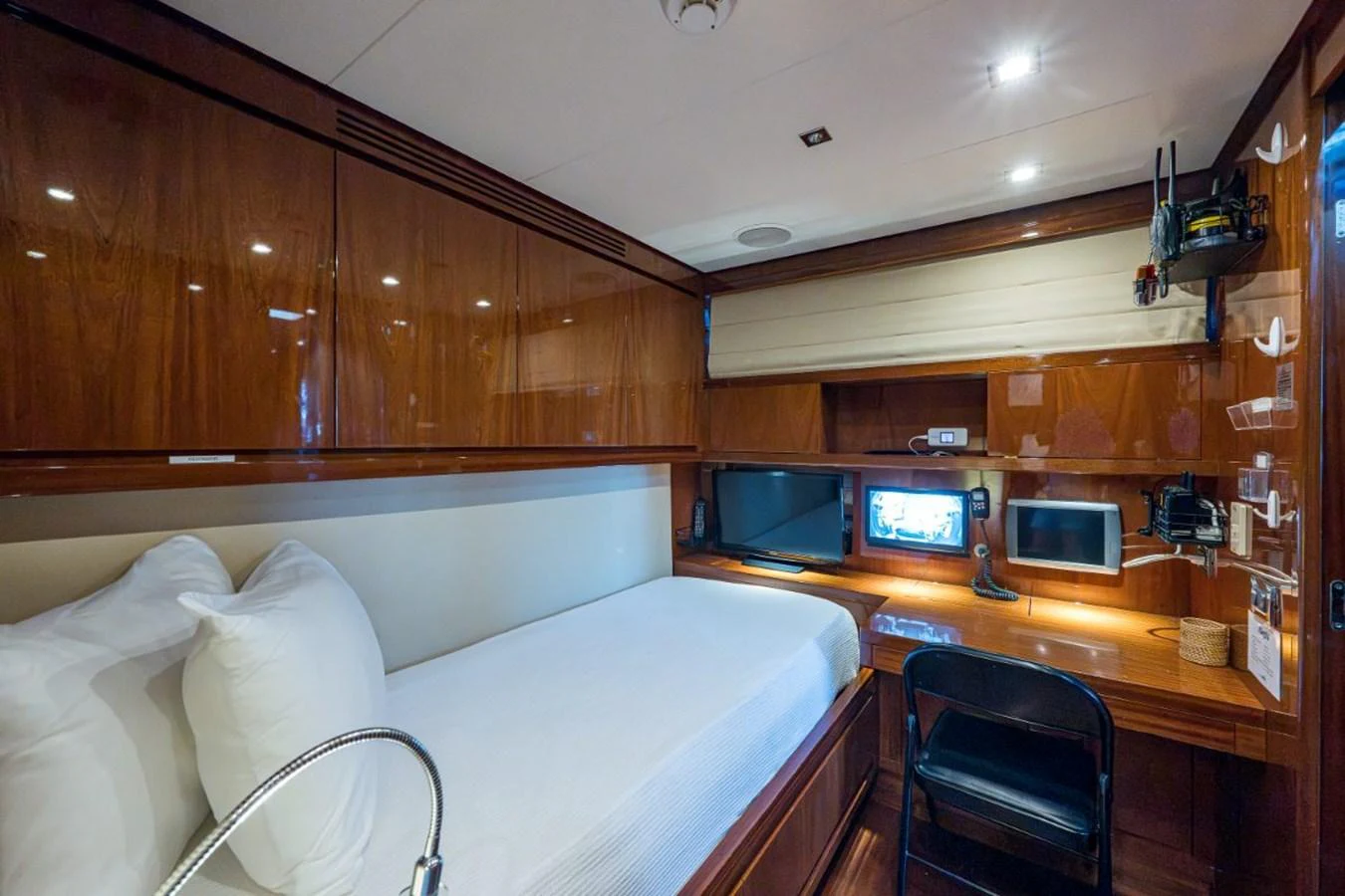 The crew cabin features a single bed, work desk, and ample storage with a polished wood finish. aboard ALEGHI Yacht for Sale