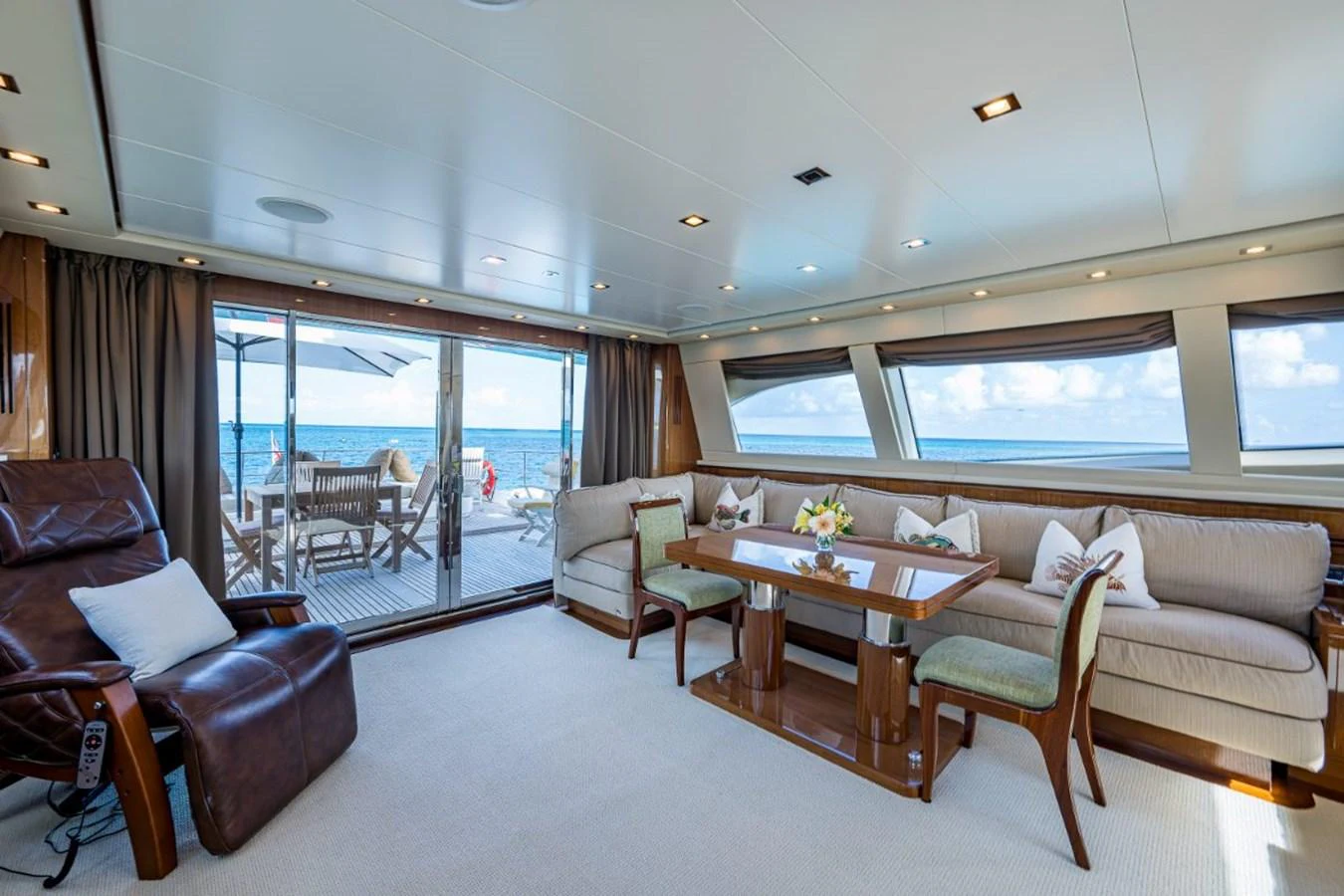 The salon offers a spacious and comfortable seating area with large windows providing stunning ocean views. aboard ALEGHI Yacht for Sale