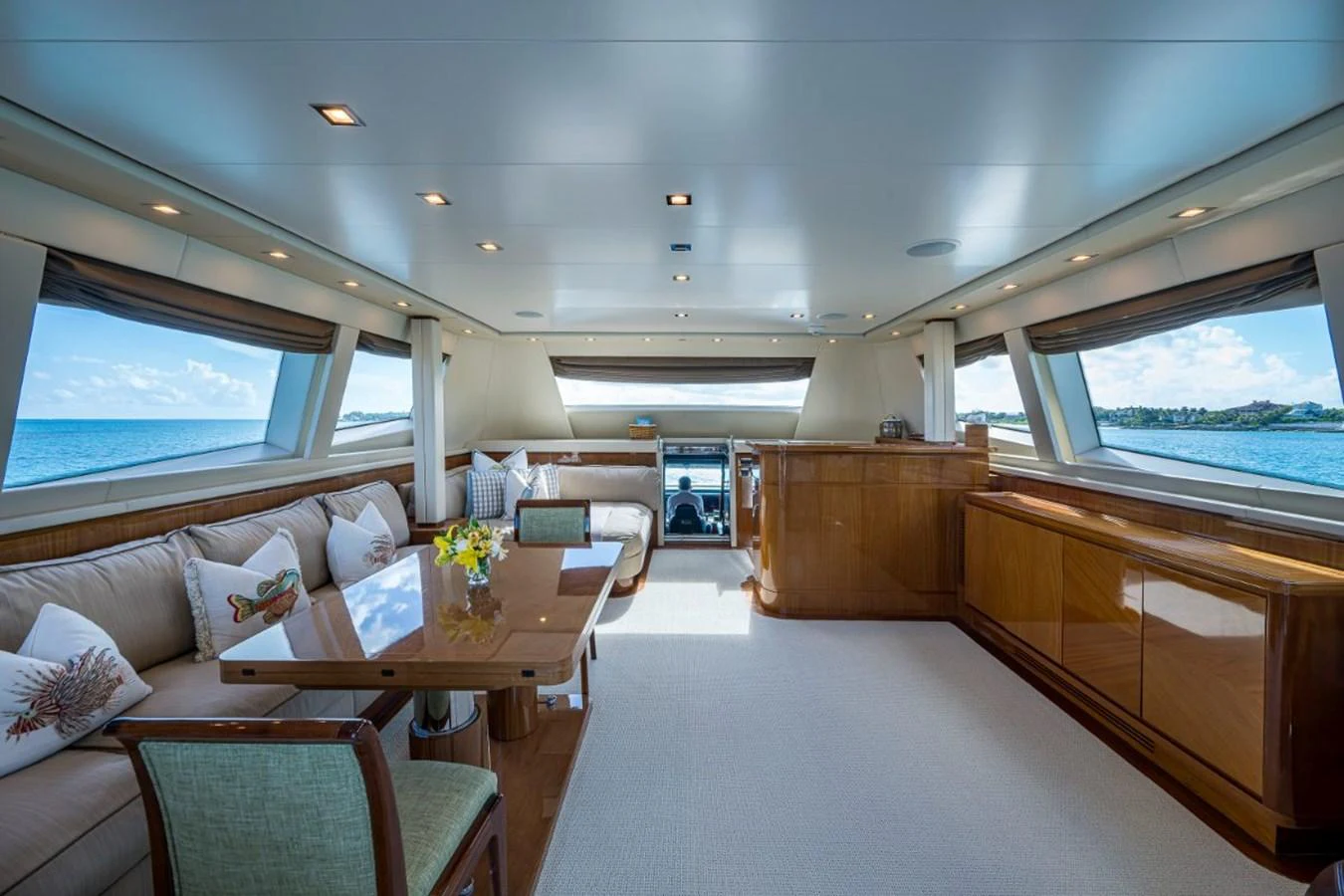The yacht's salon features elegant seating, a dining area, and panoramic windows offering stunning ocean views. aboard ALEGHI Yacht for Sale
