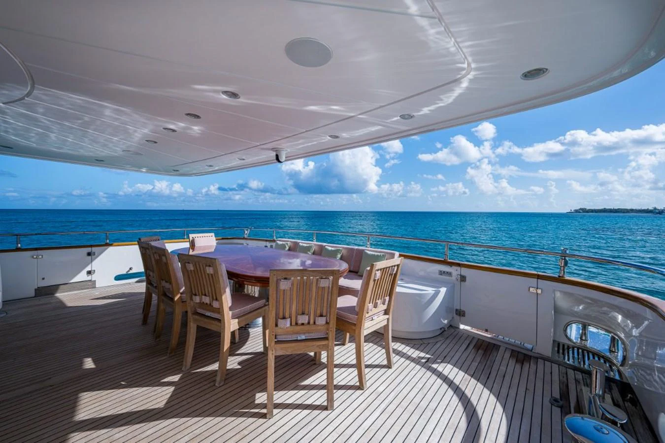 The aft deck offers a spacious dining area with stunning ocean views. aboard ALEGHI Yacht for Sale