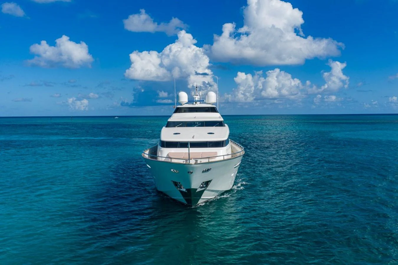 A stunning yacht cruising on clear blue waters under a bright sky. aboard ALEGHI Yacht for Sale
