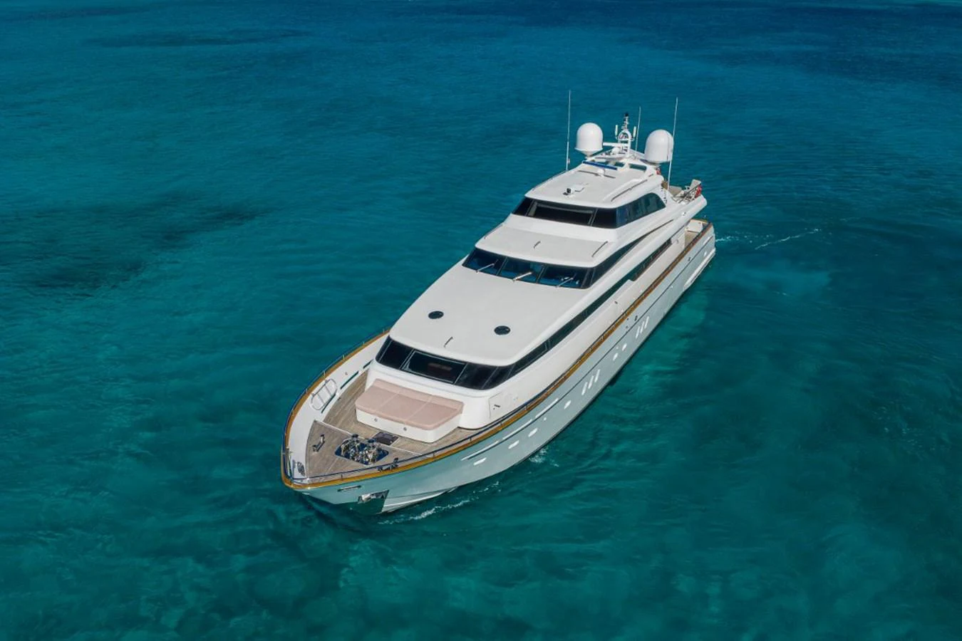 A sleek and modern yacht glides through clear turquoise waters, showcasing its elegant design. aboard ALEGHI Yacht for Sale