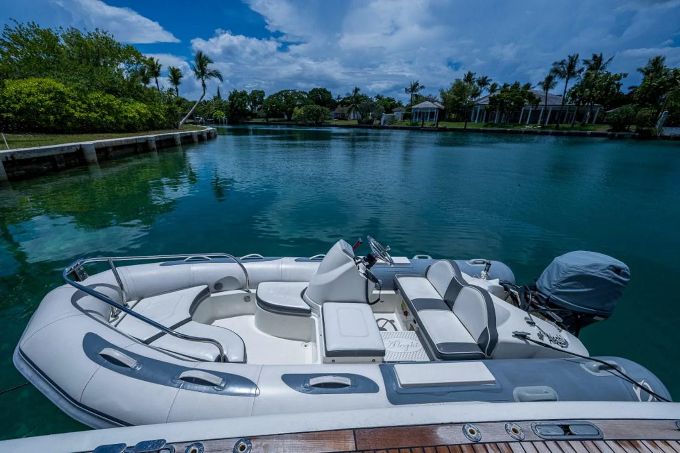 A sleek and modern tender is docked in a serene, tropical setting. aboard ALEGHI Yacht for Sale